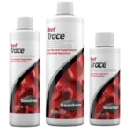Three Seachem Reef Trace bottles of varying sizes, white with red/black label, for reef aquarium trace element supplementation.