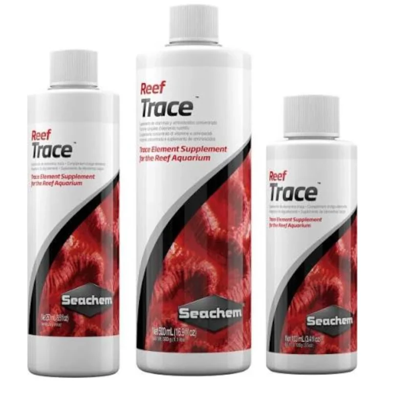 Three Seachem Reef Trace bottles of varying sizes, white with red/black label, for reef aquarium trace element supplementation.