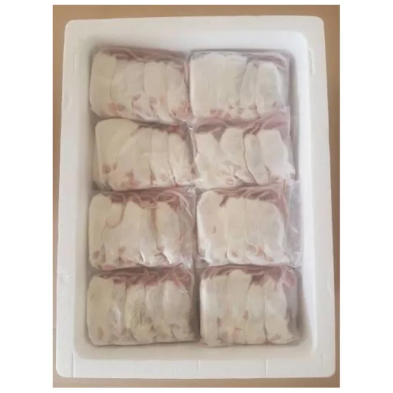 Tray of nine frozen dumplings wrapped in clear plastic, arranged in a white tray.