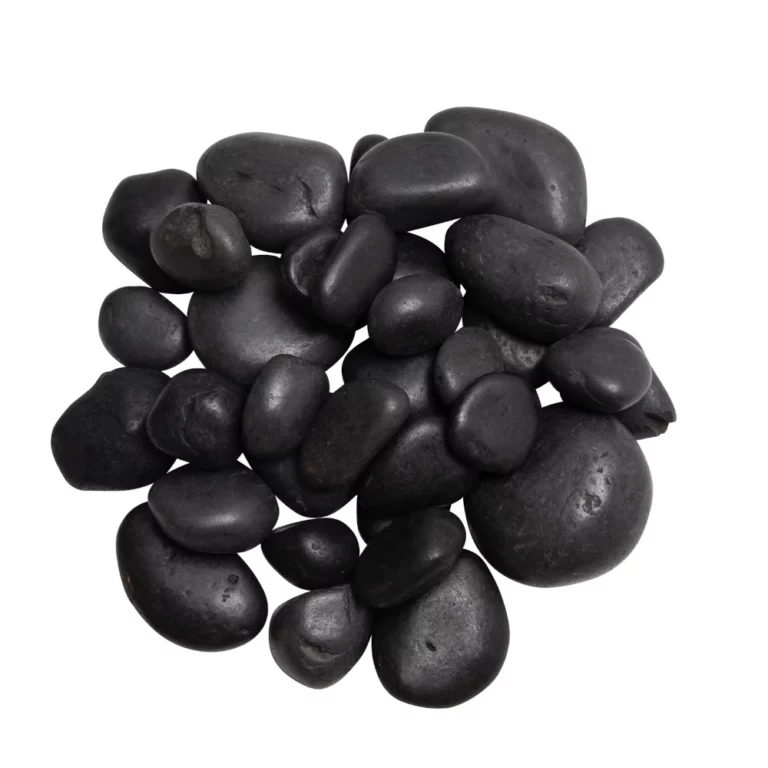 Pile of smooth black pebbles arranged together on a white background